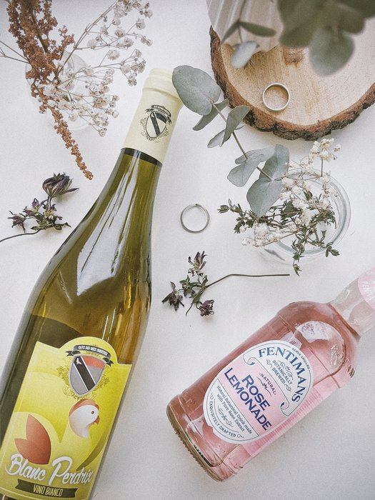 Flat lay of bottled drinks and flowers