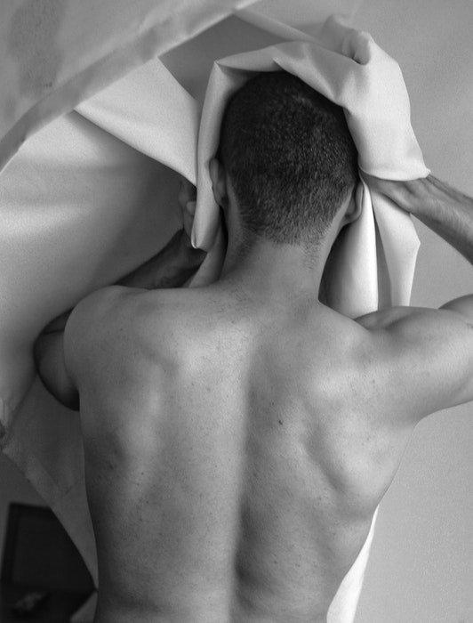 Black and white photo of the back of a male model