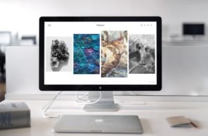 Desktop computer with stock photography images on the screen