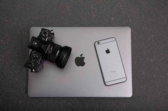 A DSLR camera, iPhone and a laptop