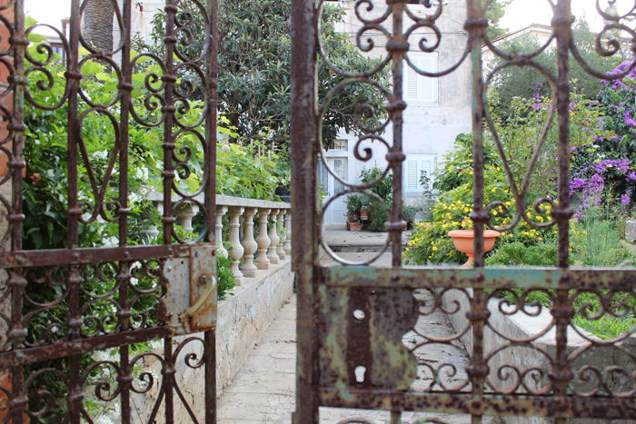 an image of a garden through an iron gate shot with a Canon 1300D