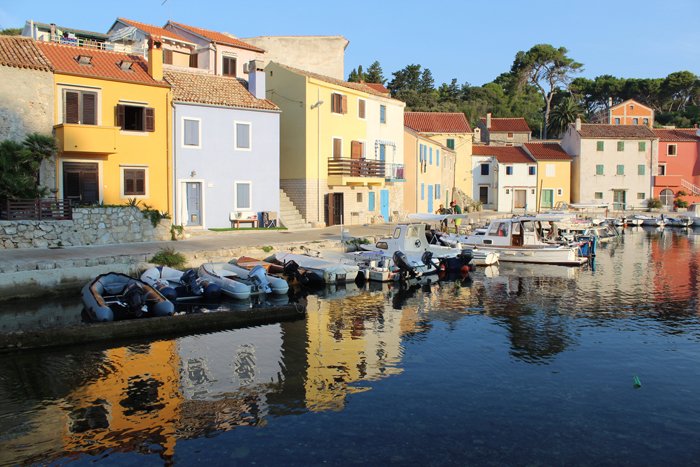 an image of boats docked in front of colourful houses