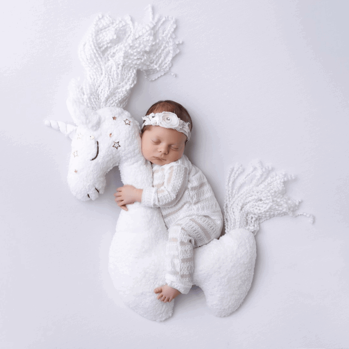 Baby riding a unicorn from baby photographer ana brandt