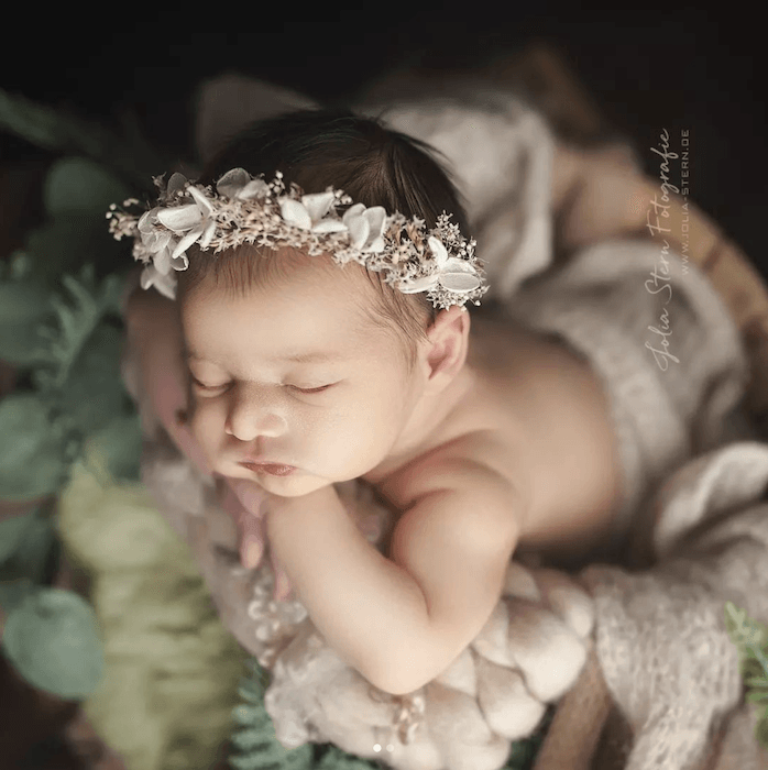 Baby sleeping in flowers from famous baby photographer jolia stern