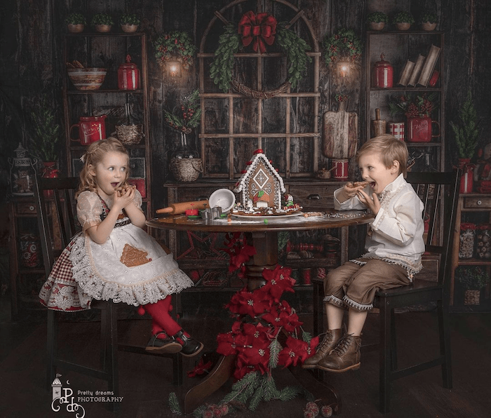Kids eating a gingerbread house from best baby photographer sonia gourlie