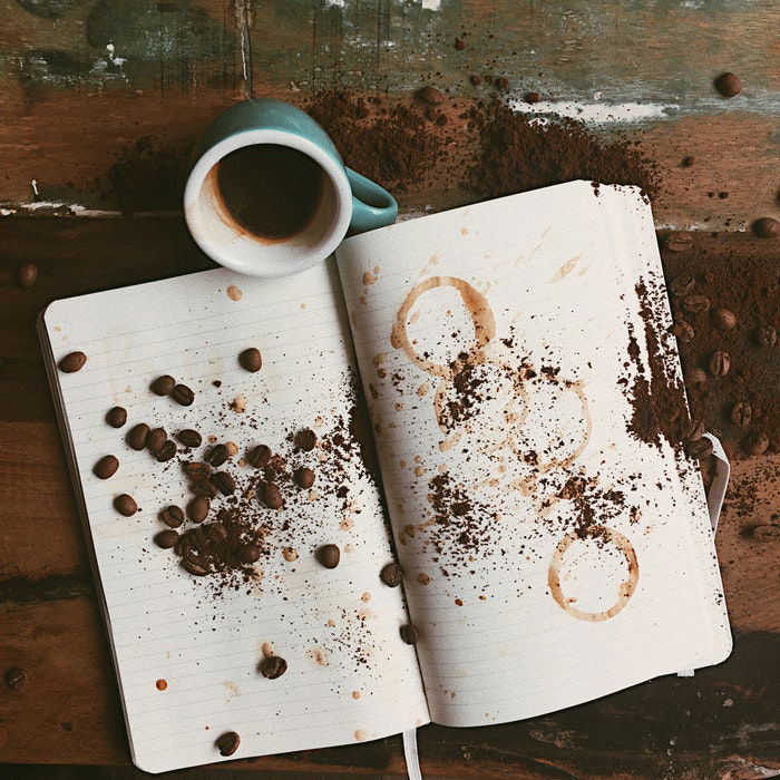 Coffee Splash Photography: overhead photo of an open notebook with a small mug of coffee next to it