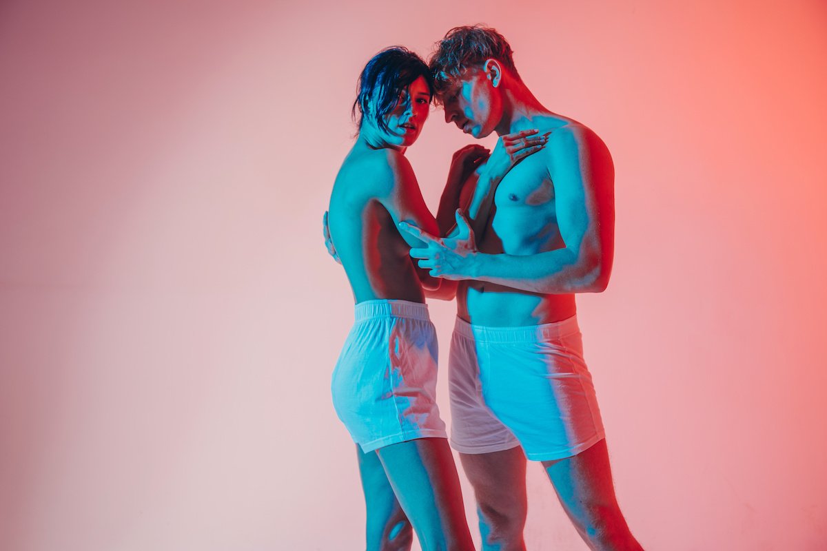 A woman and man standing in underwear for couples boudoir photography