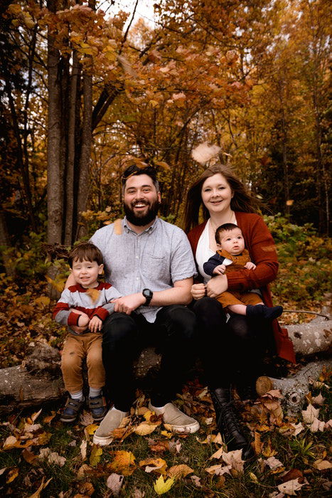 A family of four posing outdoors