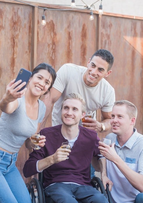A group of friends posing for a natual light selfie outdoors