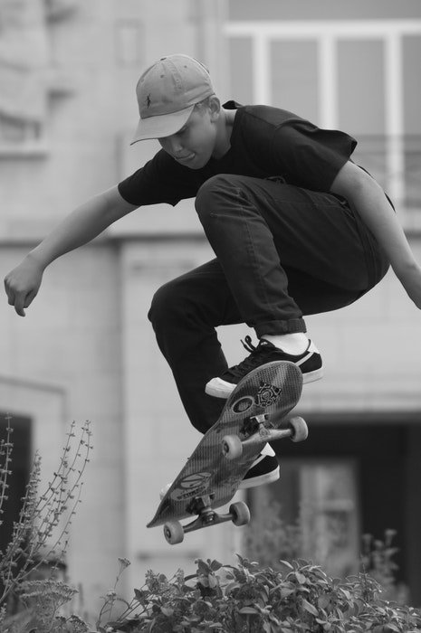 black and white photo of a skateboarder jumping