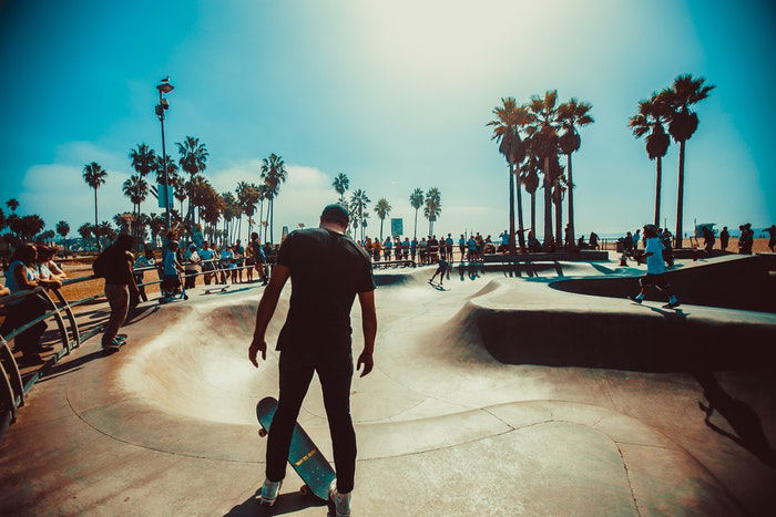 photo of a skateboarder standing on the edge of the ramp