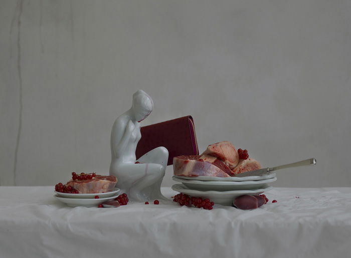 abstract still life photo with a small sculpture and two plates of food