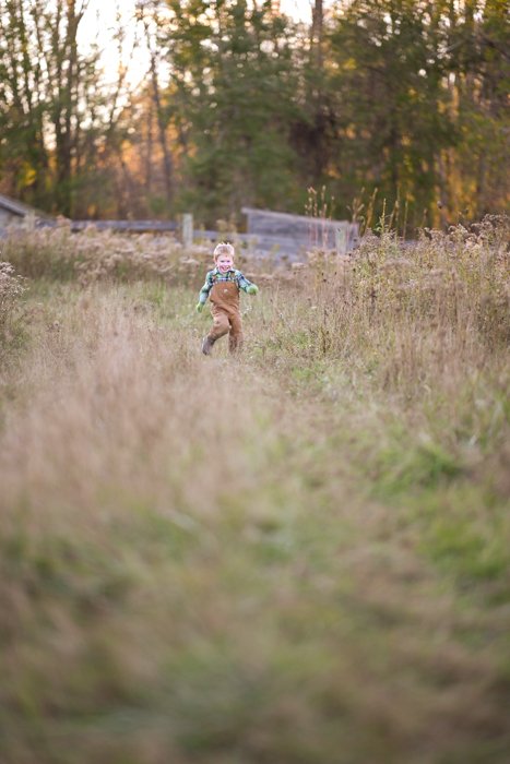 Male child running through a field towards the camera