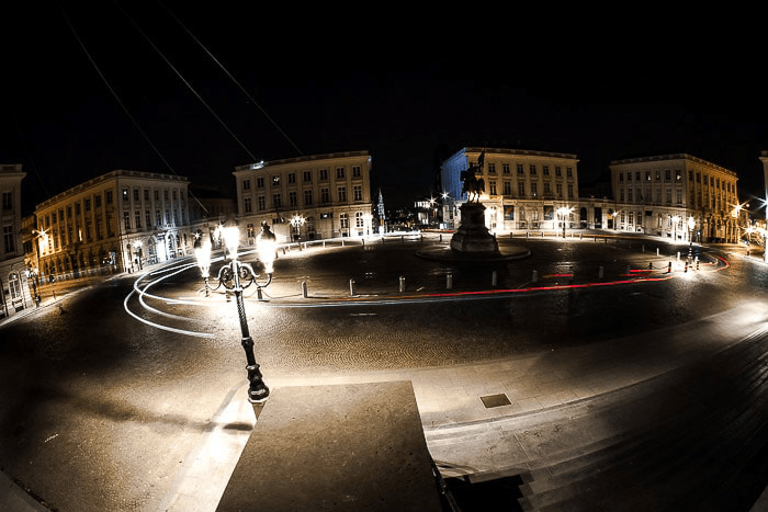 Light trails of motion blur creating an urban light carousel in Place Royale in Brussels Belgium