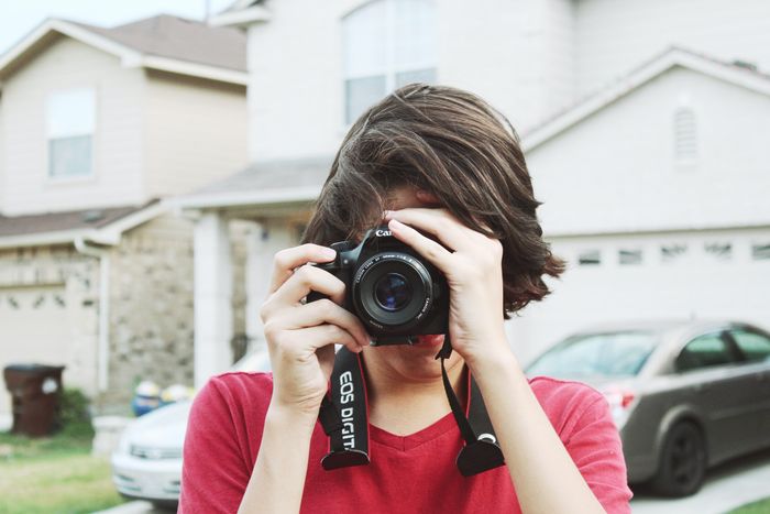 photo of a guy taking a photo with a dslr camera 