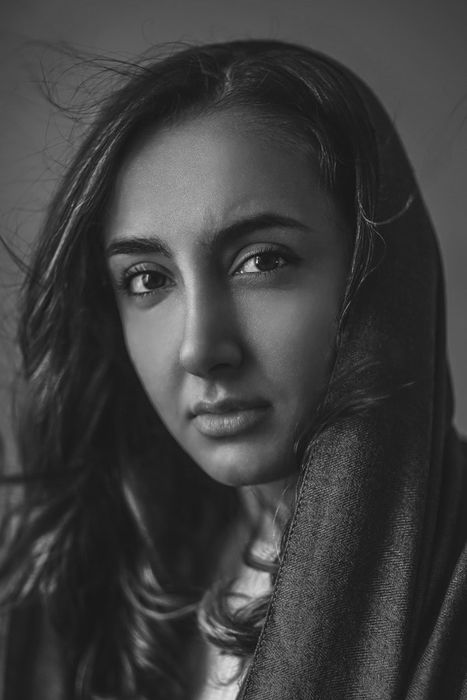 A black and white portrait of a female model