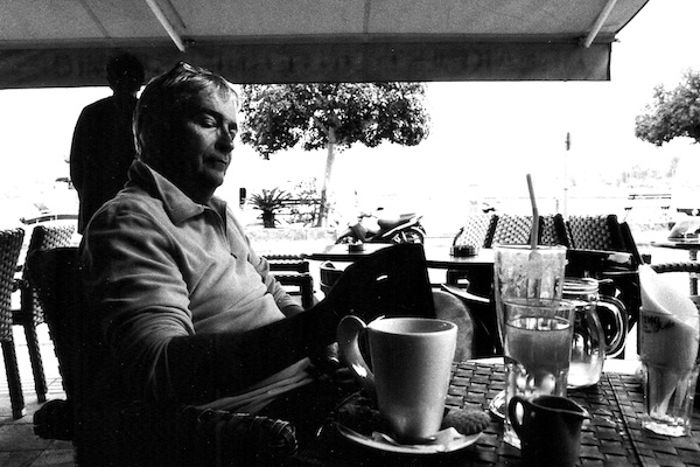 Black and white lifestyle photo of a man having coffee