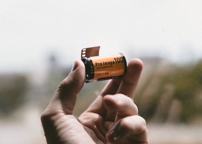 a PERSON HOLDING A ROLL OF FILM