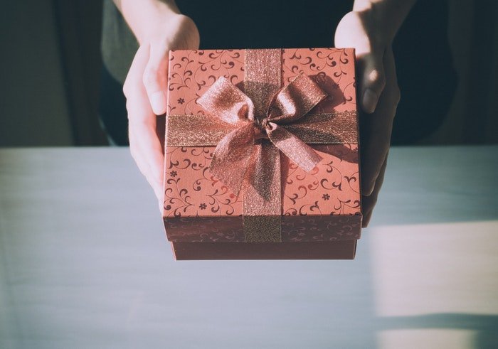 A person holding a gift box