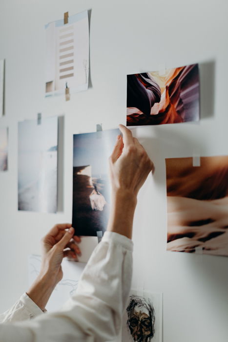 A person sticking a printed image to a wall