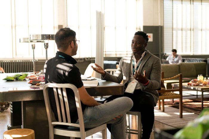 Two men having a photography marketing meeting