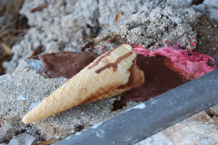 A fallen melting ice-cream cone