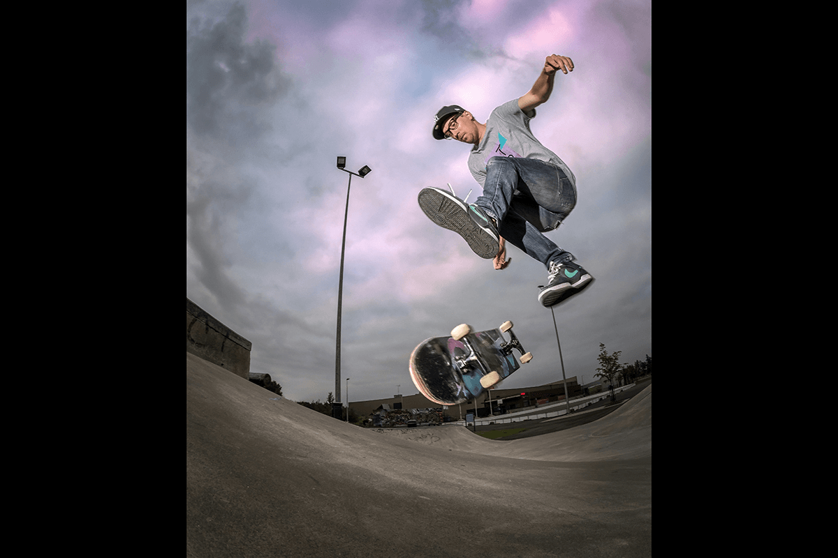 A skateboarder doing a trick taken with a fisheye lens as an example of skateboard photography