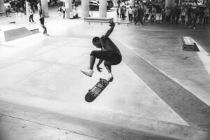 A skateboarder doing a trick in a city square shot from a high angle as an example for skateboard photography