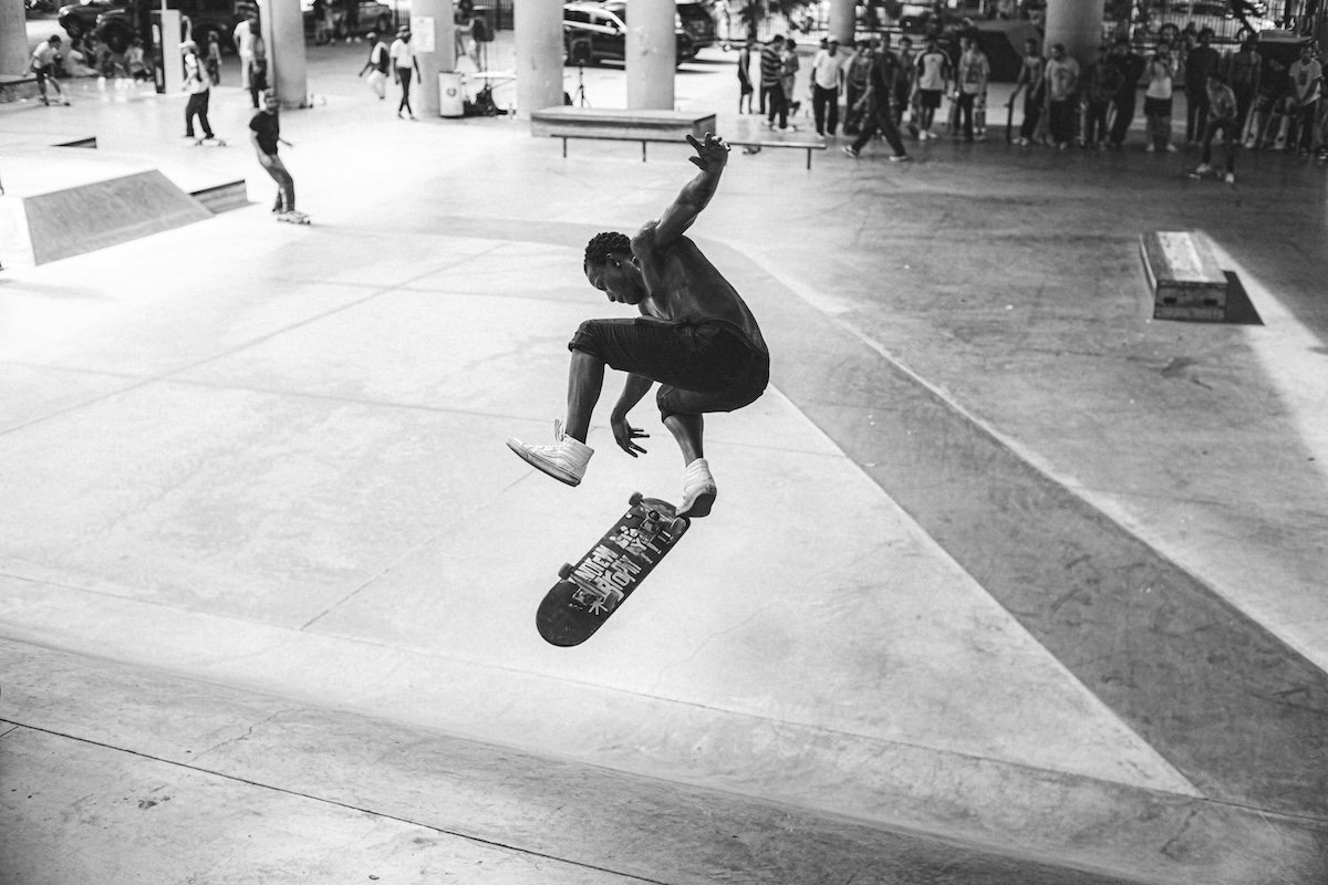 A skateboarder in a mid-air trick in an urban skate park as an example of sports photography