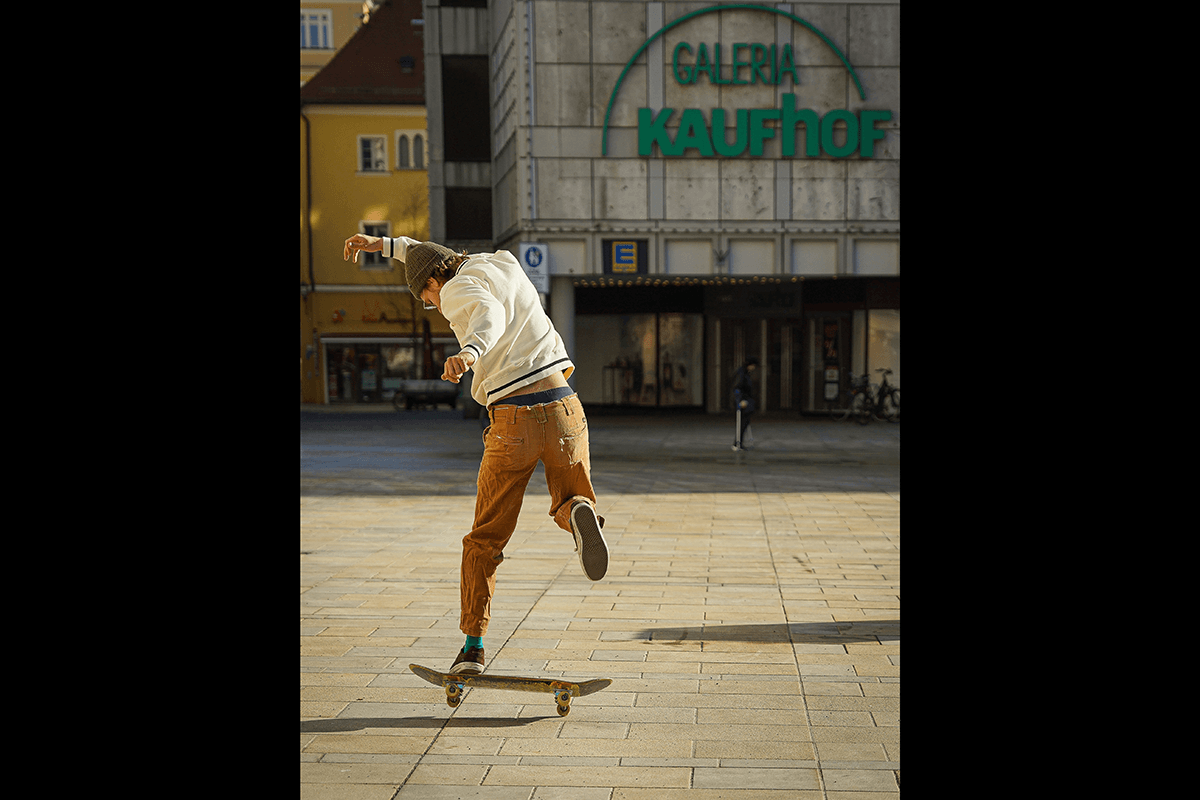 A skateboarder doing a backwards trick as an example of skateboard photography