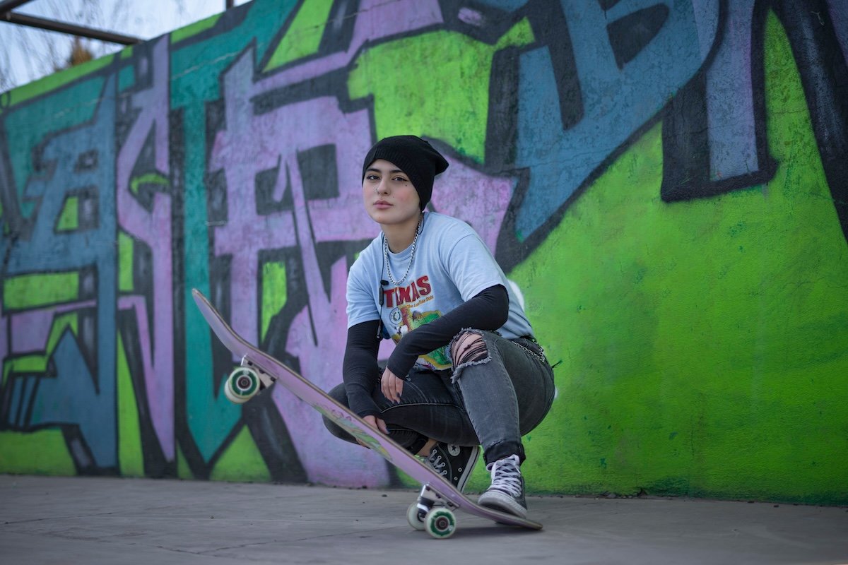 Portrait of a skateboarder against a graffiti backdrop as an example of skateboard photography