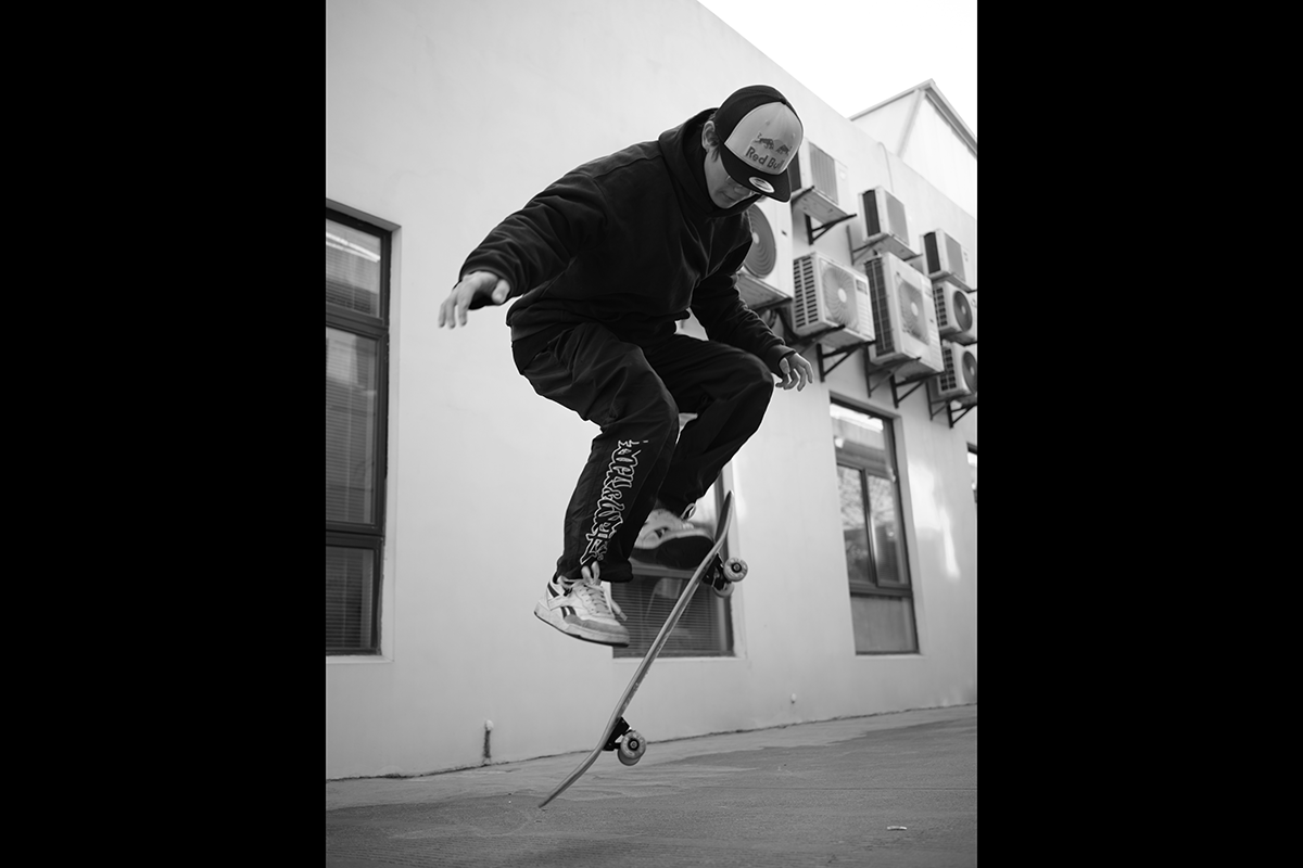 A low-angle shot of a skateboarder doing a trick as an example for skateboard photography