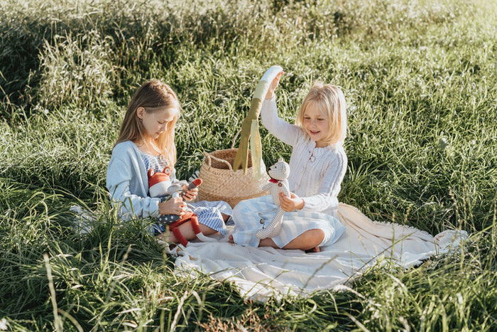 Portrait of two little girls playing with toys