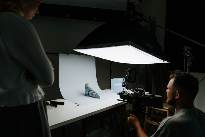 A photographer shooting a toy photography shot in a studio