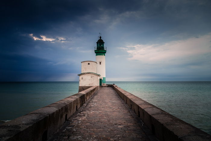 lighthouse on a beach with vignette around the edges of the photo