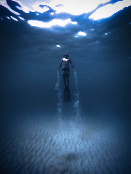 Photo of a diver underwater with vignette around the edges