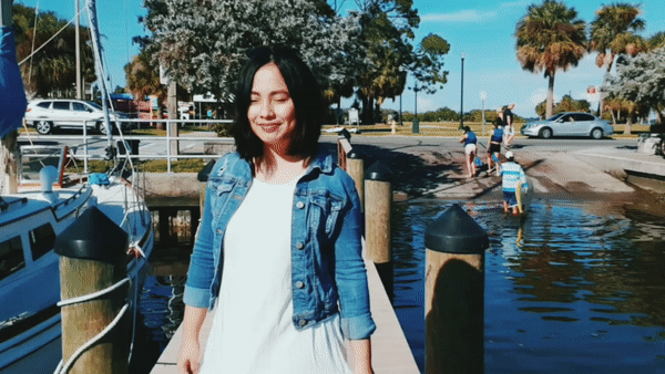 Gif of a girl walking around a harbour