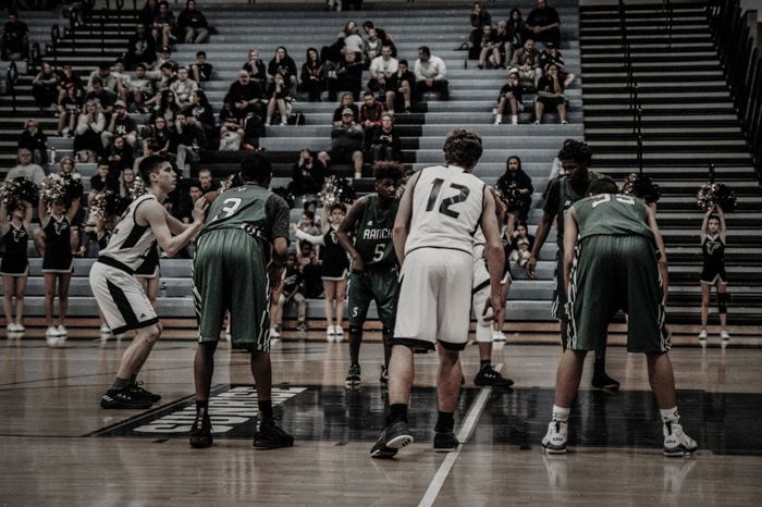 7 players on a basketball game, waiting for one of them to throw the ball. 