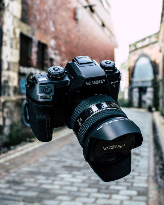 A Minolta camera flying through the air