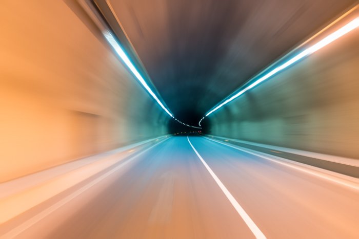 tunnel inside background with speed driving blurred motion toward the central