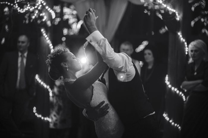 Black and white image of the wedding dance of beautiful young newlywed couple