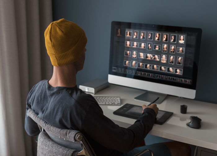 Man working at home editing pictures on computer