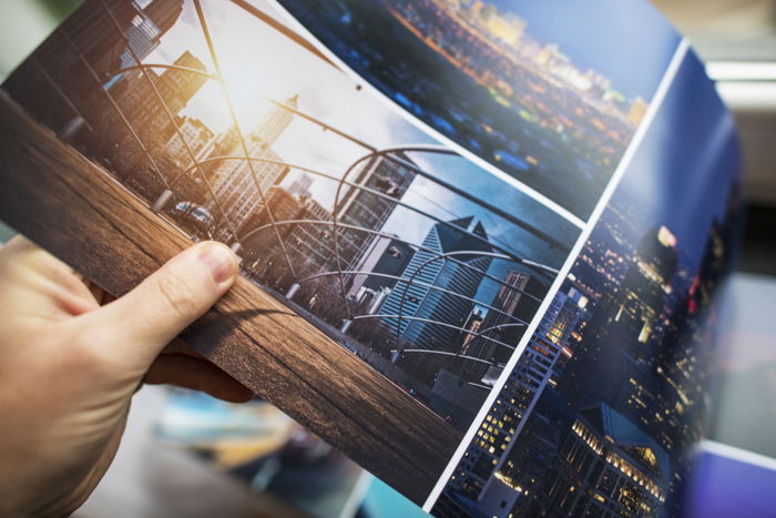 A man checking on Print Quality of the Photo Custom Digitally Printed Album.