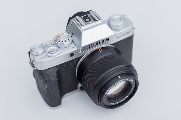 Image of the Fujifilm XC 35mm f/2 lens attached on the Fujifilm X-T200