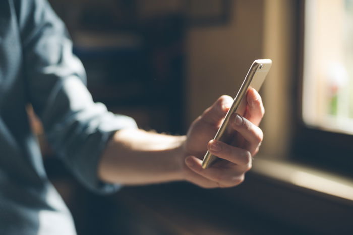 an image of a woman's arm holding a smartphone