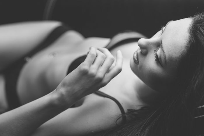 Boudoir portrait of a girl in lingerie lying on her back