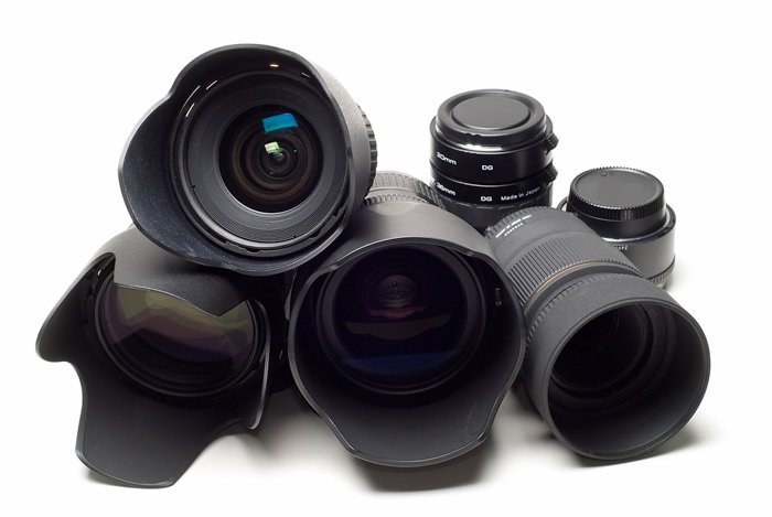 A pile of camera lenses on white background.