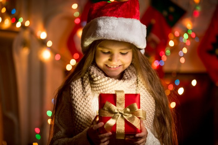 Festive portrait of a little girl in a Santa hat