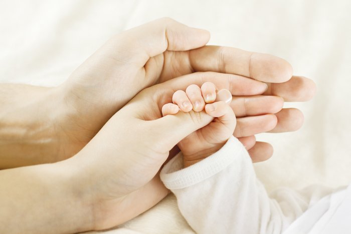 Capturing a baby's hands with their parents