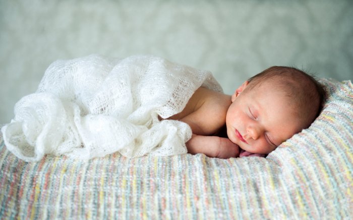 Newborn side pose with a blanket